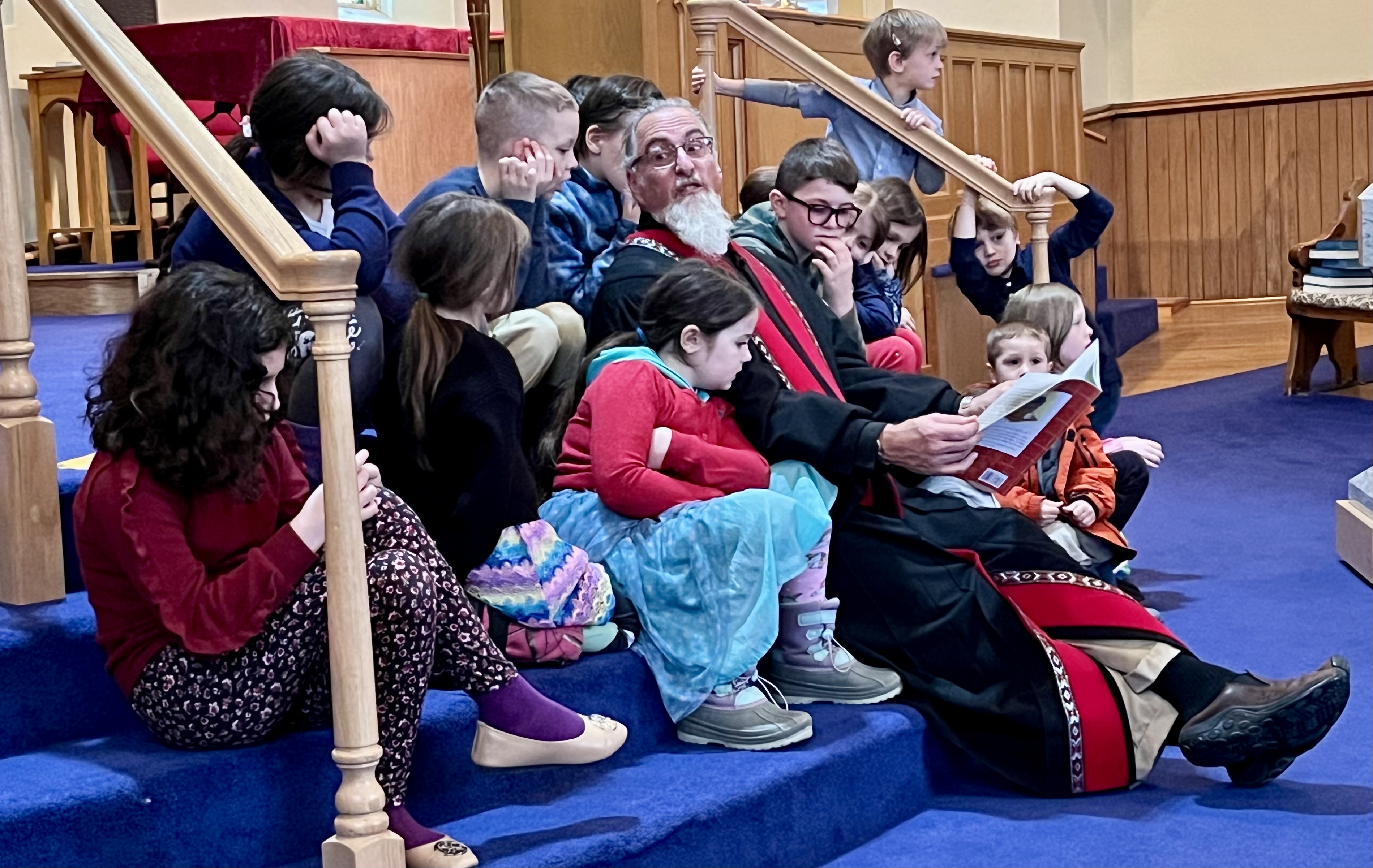 Rev. Mike reads to the kids.